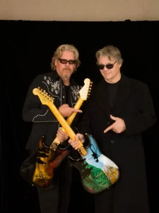 2 men holding guitars