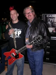 2 men holding a guitar