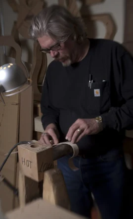 Man making guitar pieces