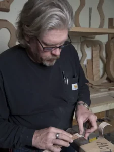 Man building guitars